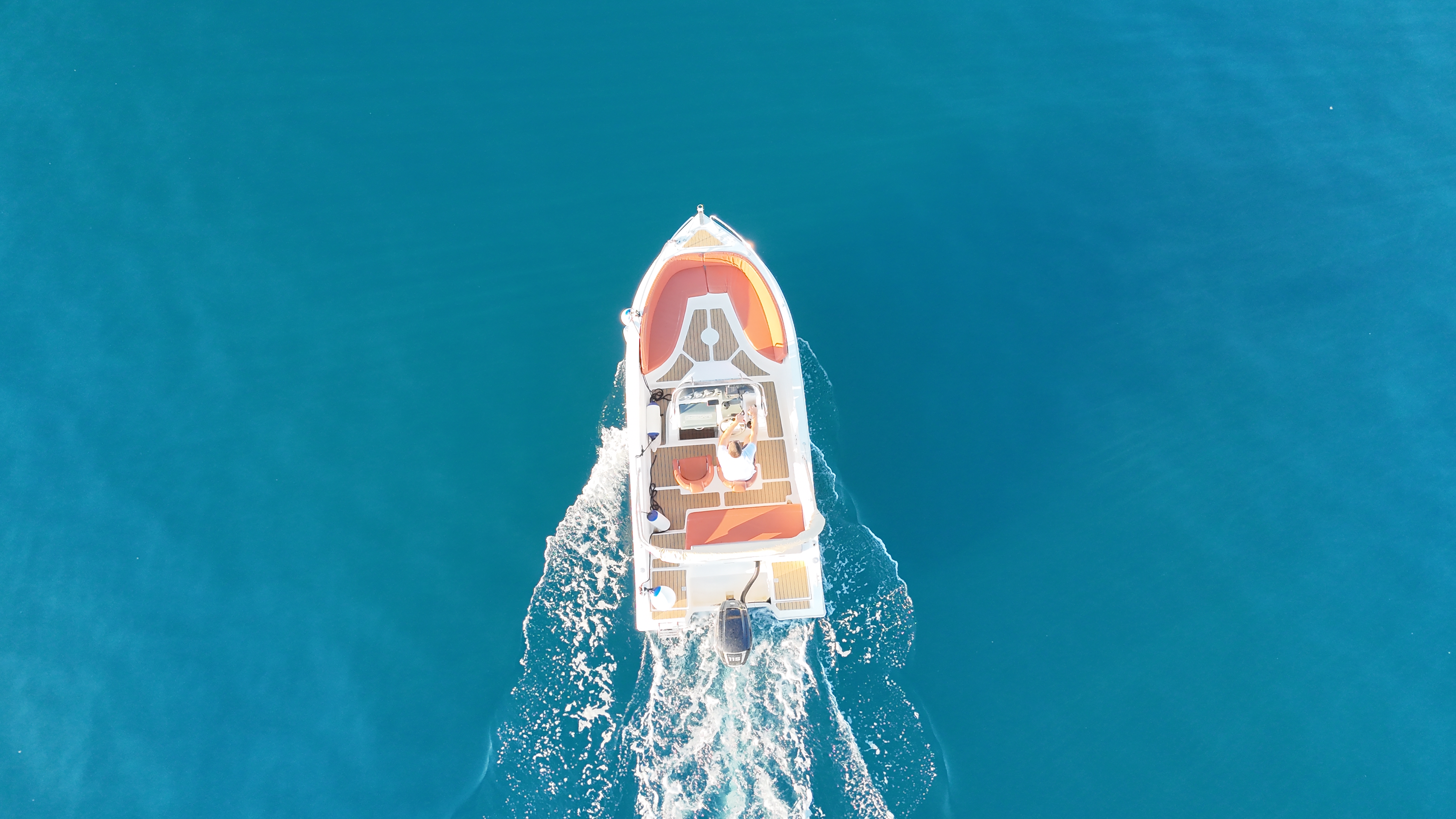 Boat traveling in blue waters